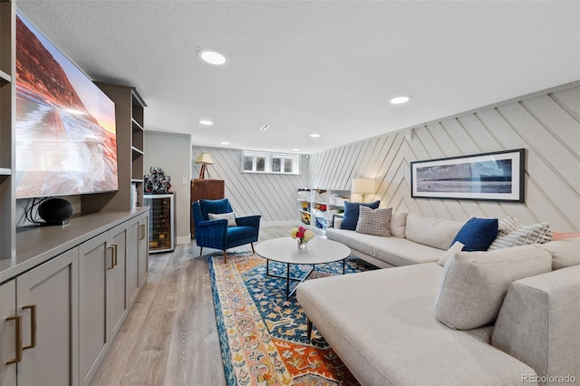 living area with recessed lighting and light wood-style flooring