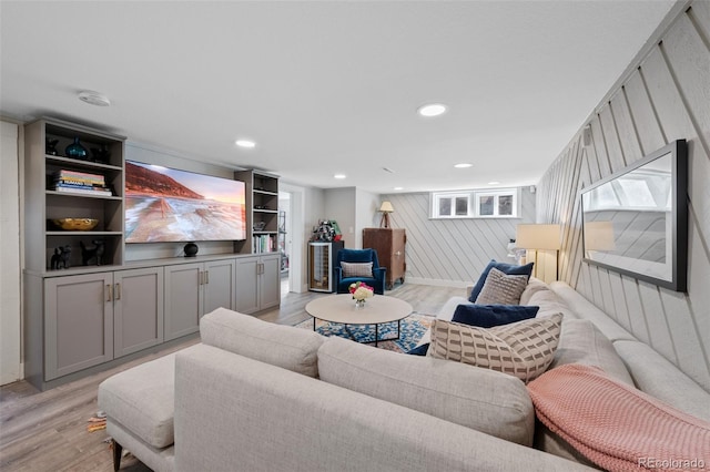 living room with light wood-style floors and recessed lighting