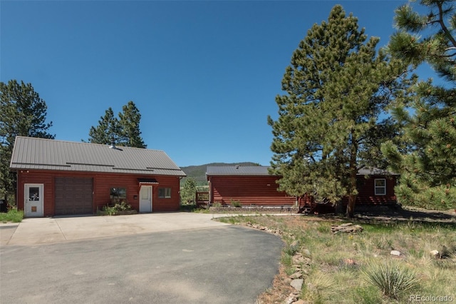 3126 Singletree Rd, Hartsel, CO 80449 - view of side of home with concrete driveway, a metal roof, and a standing seam roof