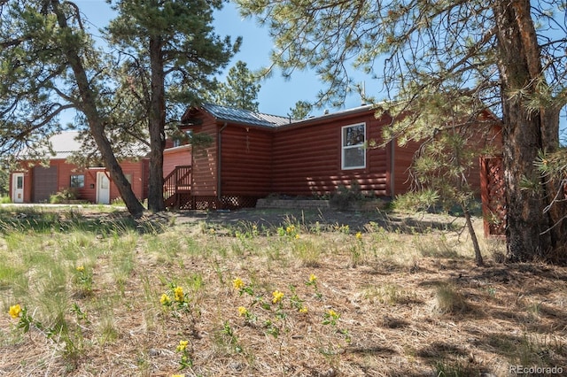 3126 Singletree Rd, Hartsel, CO 80449 - view of home's exterior featuring log veneer siding and a metal roof