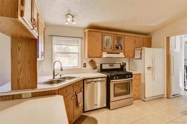 3126 Singletree Rd, Hartsel, CO 80449 - kitchen featuring appliances with stainless steel finishes, under cabinet range hood, light countertops, light tile patterned floors, and a textured ceiling