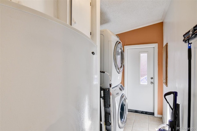 3126 Singletree Rd, Hartsel, CO 80449 - laundry area featuring stacked washer / dryer, a textured ceiling, light tile patterned floors, and crown molding