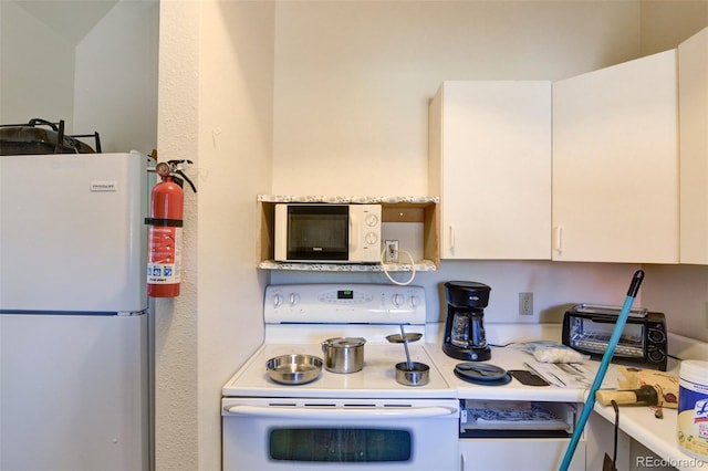 3126 Singletree Rd, Hartsel, CO 80449 - kitchen with white appliances, white cabinets, and light countertops