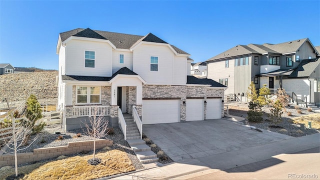 view of front of home featuring driveway, a porch, a shingled roof, stone siding, and a garage