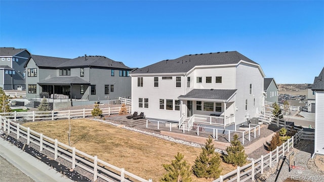 rear view of house featuring a residential view, a patio, and a fenced backyard