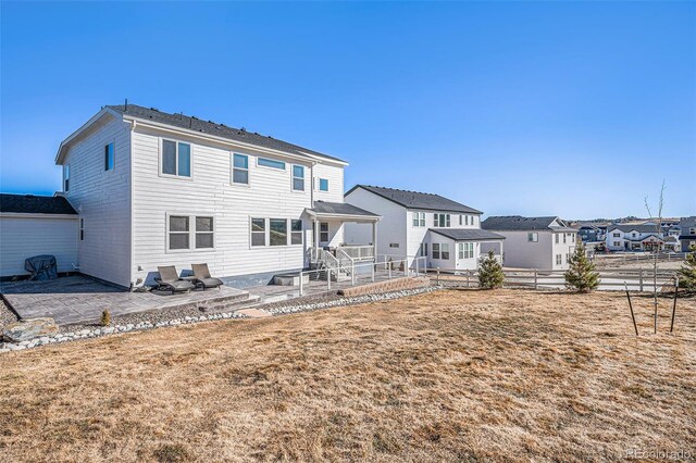 rear view of property with fence, a patio area, and a residential view