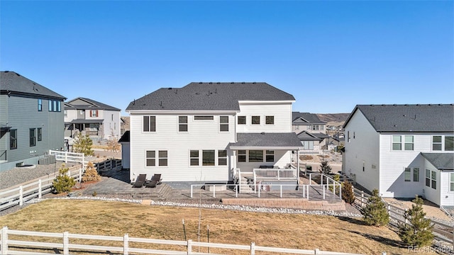 back of house with a residential view, a patio, a fenced backyard, and roof with shingles