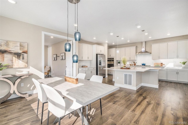 dining area featuring recessed lighting, wood finished floors, and visible vents