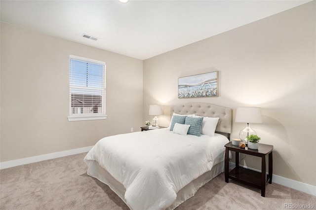 carpeted bedroom featuring visible vents and baseboards