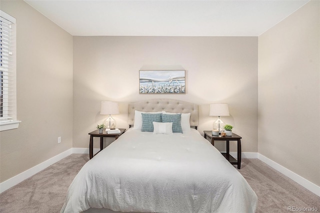 bedroom featuring baseboards and light carpet