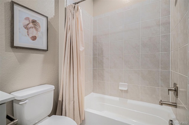 full bath featuring toilet, shower / tub combo with curtain, and a textured wall