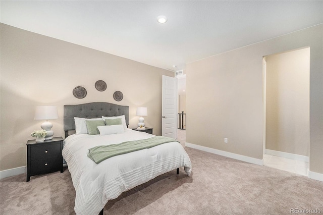 carpeted bedroom with visible vents and baseboards