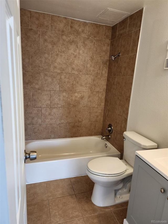 full bathroom with vanity, toilet, tiled shower / bath combo, and tile patterned flooring