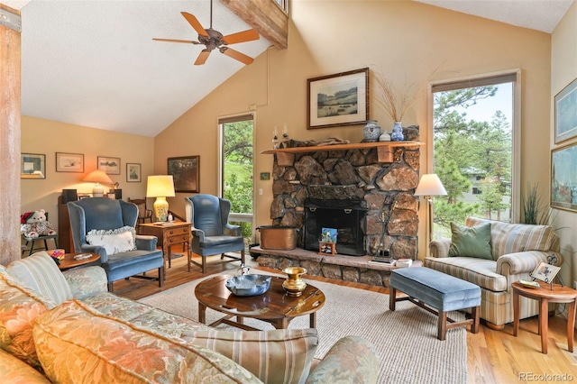 207 Kelly Rd E, Boulder, CO 80302 - living room featuring wood finished floors, ceiling fan, beam ceiling, a stone fireplace, and high vaulted ceiling