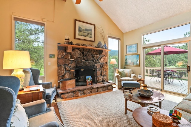 207 Kelly Rd E, Boulder, CO 80302 - living room with high vaulted ceiling, wood finished floors, a ceiling fan, a fireplace, and a textured ceiling