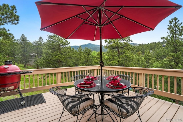 207 Kelly Rd E, Boulder, CO 80302 - wooden deck featuring outdoor dining space and a wooded view