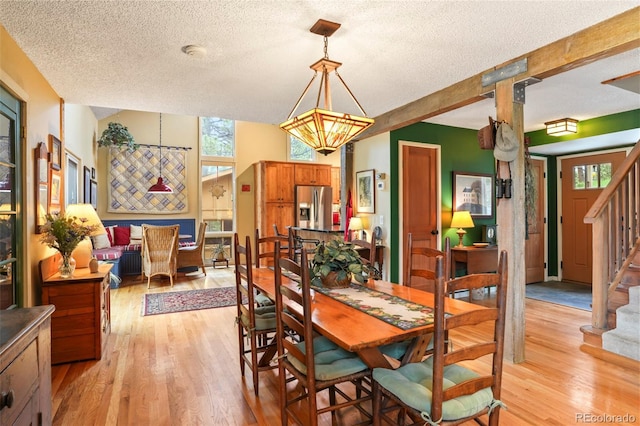 207 Kelly Rd E, Boulder, CO 80302 - dining space featuring a textured ceiling, light wood-style flooring, and stairway