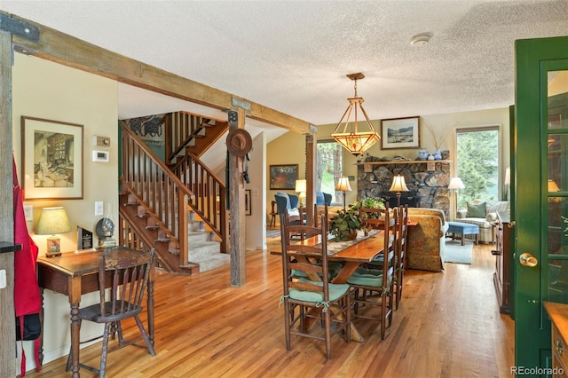 207 Kelly Rd E, Boulder, CO 80302 - dining space with wood finished floors, a textured ceiling, and stairs