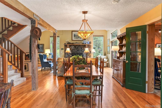 207 Kelly Rd E, Boulder, CO 80302 - dining area with a textured ceiling, plenty of natural light, stairway, light wood finished floors, and vaulted ceiling
