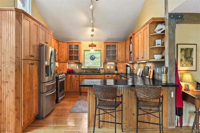 207 Kelly Rd E, Boulder, CO 80302 - kitchen featuring stainless steel appliances, a peninsula, open shelves, lofted ceiling, and tasteful backsplash