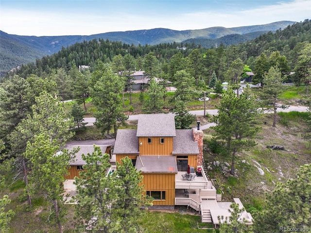 207 Kelly Rd E, Boulder, CO 80302 - aerial view of property and surrounding area with a forest and a mountain backdrop
