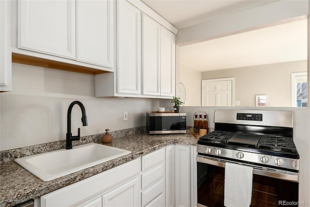 kitchen with a sink, white cabinets, and stainless steel appliances