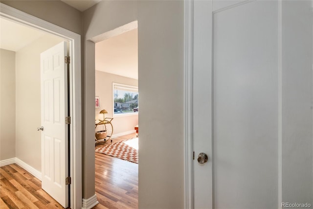 hallway with baseboards and light wood-style flooring