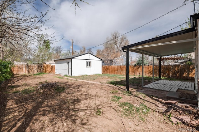 view of yard with a fenced backyard and an outdoor structure