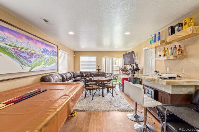 interior space featuring a textured ceiling and hardwood / wood-style floors