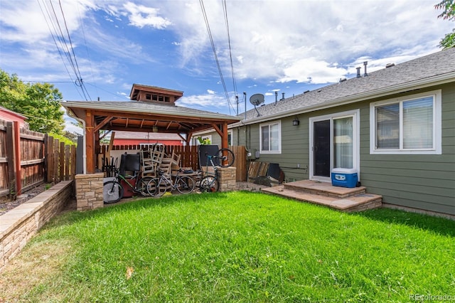 back of house featuring a gazebo and a lawn