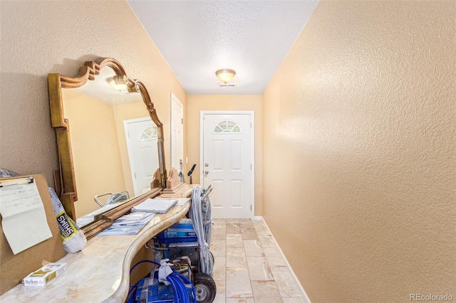 entryway with a textured ceiling