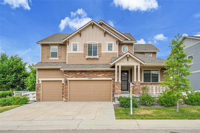 20145 E Fair Ln, Centennial, CO 80016 - craftsman-style house with an attached garage, driveway, board and batten siding, a shingled roof, and stone siding