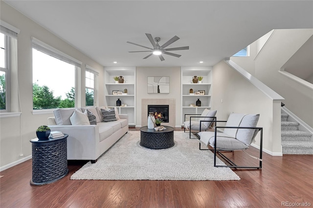 20145 E Fair Ln, Centennial, CO 80016 - living area with a ceiling fan, wood finished floors, stairs, built in features, and a tile fireplace