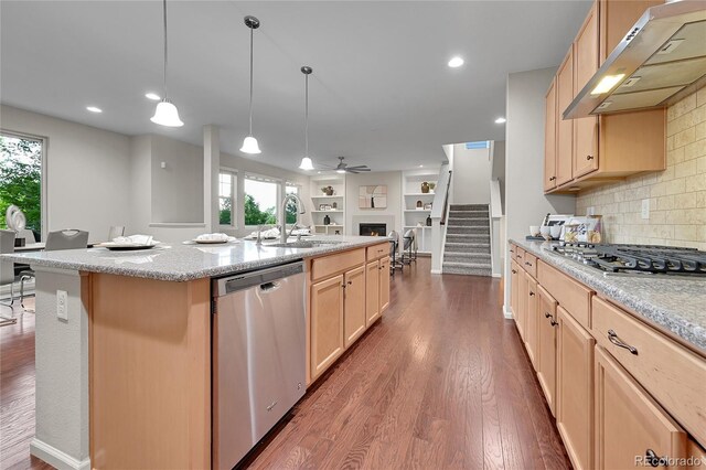 20145 E Fair Ln, Centennial, CO 80016 - kitchen with appliances with stainless steel finishes, under cabinet range hood, open floor plan, dark wood-style floors, and decorative backsplash