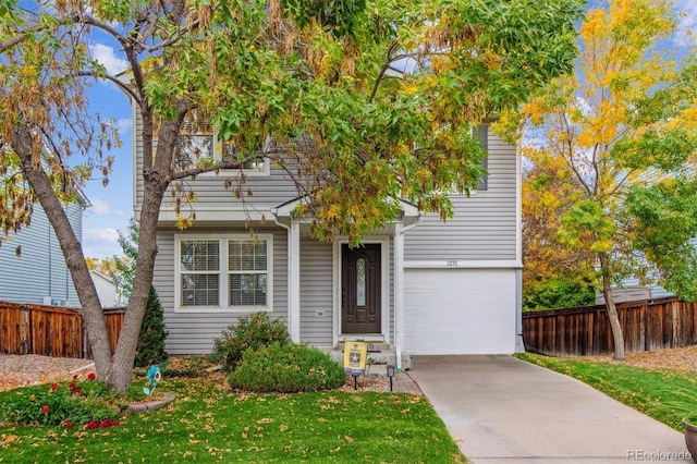 view of front of house with a front lawn and a garage