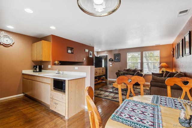 dining space featuring sink and dark hardwood / wood-style floors