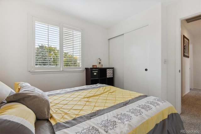 carpeted bedroom with a closet