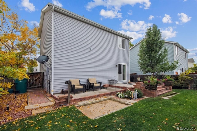 rear view of property featuring a patio and a yard