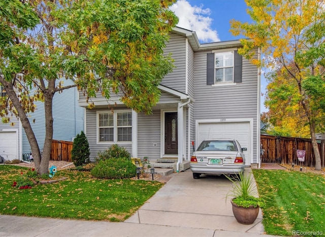 view of front of home with a front yard and a garage