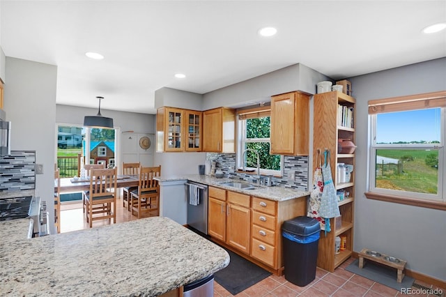 kitchen with sink, appliances with stainless steel finishes, decorative backsplash, tile patterned flooring, and pendant lighting