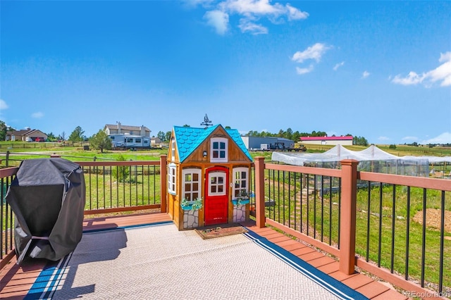 wooden terrace featuring a lawn