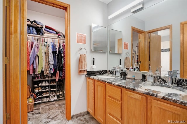 bathroom with tile patterned flooring and double vanity