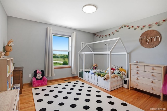 bedroom with hardwood / wood-style floors