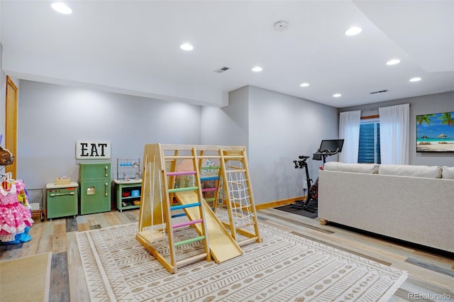 recreation room with light wood-type flooring