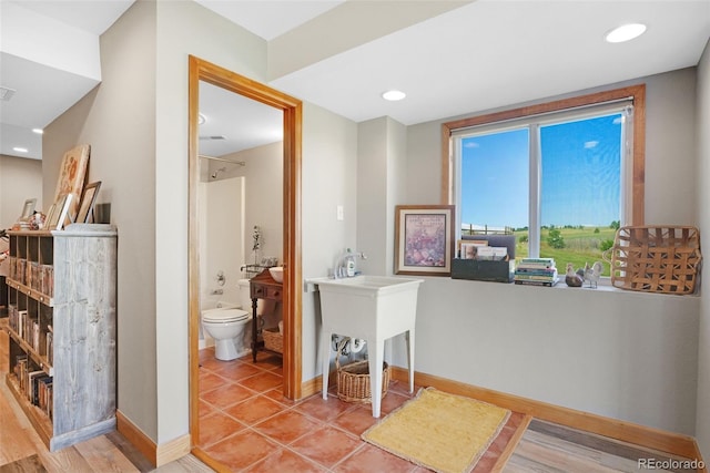 bathroom featuring tile patterned flooring, toilet, and vanity