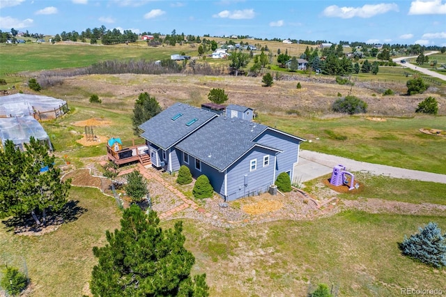 birds eye view of property with a rural view