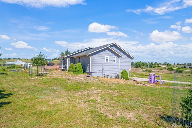 exterior space featuring a yard and cooling unit