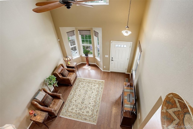 4784 Raven Run, Broomfield, CO 80023 - entryway with baseboards, a high ceiling, a ceiling fan, and wood finished floors