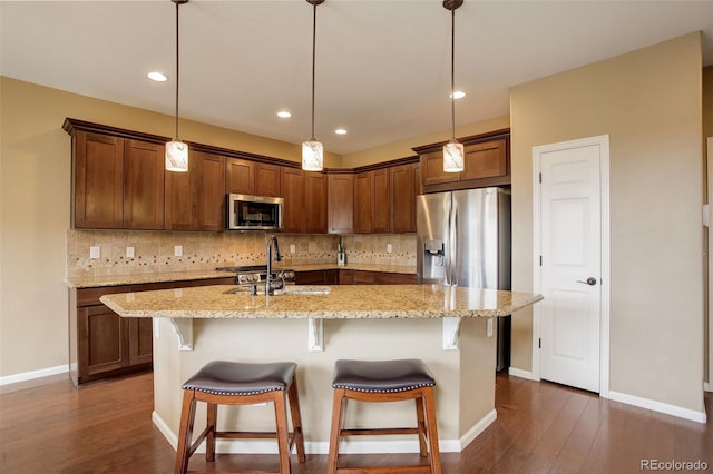 4784 Raven Run, Broomfield, CO 80023 - kitchen with dark wood-style flooring, stainless steel appliances, and tasteful backsplash