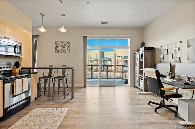 home office with light wood-type flooring